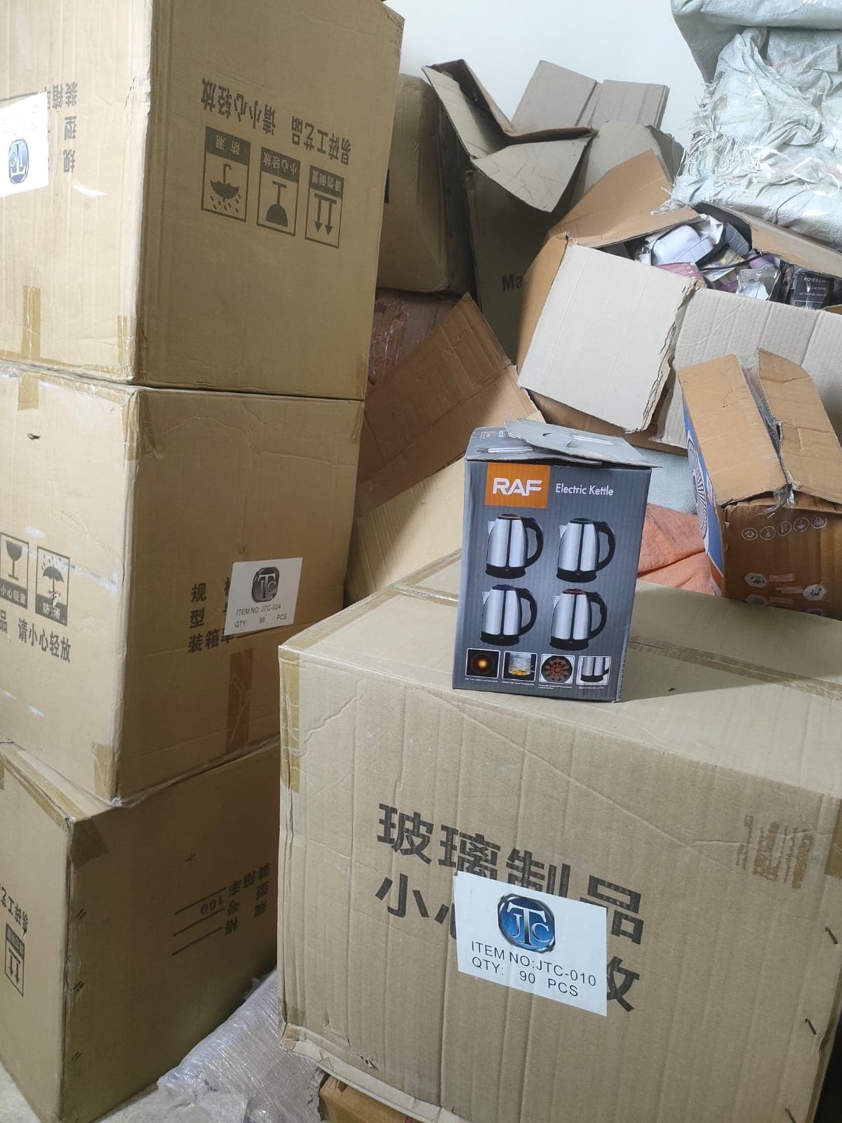 Electric kettle stock beside wholesale cartons at SimpleCart Store